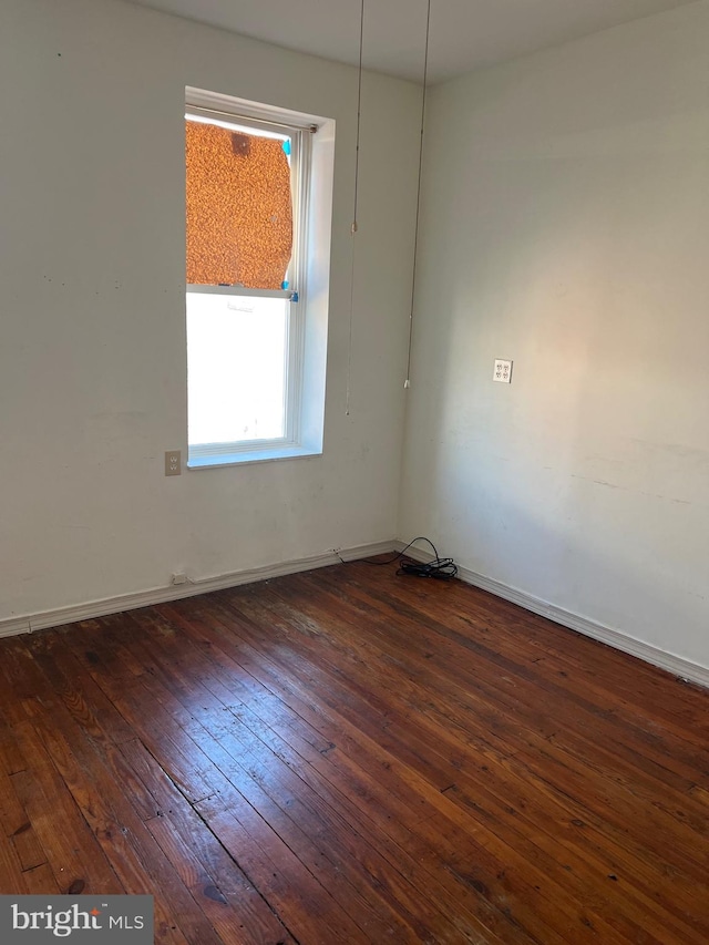 spare room with dark wood-type flooring