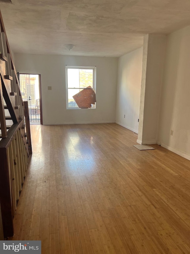 unfurnished room with light wood-type flooring