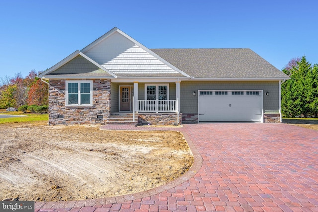 craftsman-style home with covered porch and a garage