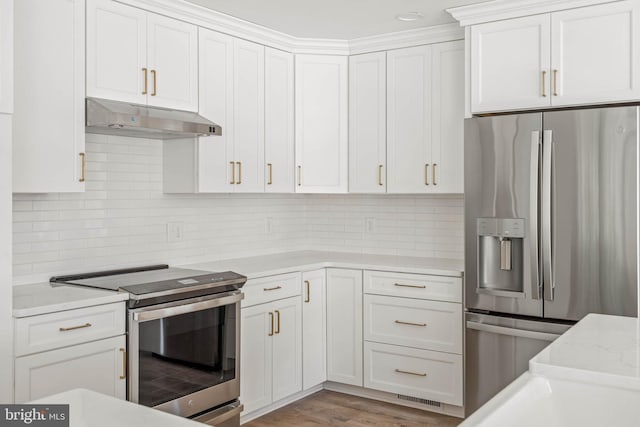 kitchen with decorative backsplash, appliances with stainless steel finishes, light hardwood / wood-style floors, and white cabinetry