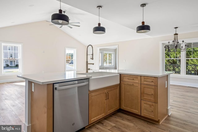 kitchen with light hardwood / wood-style flooring, stainless steel dishwasher, a center island with sink, and sink