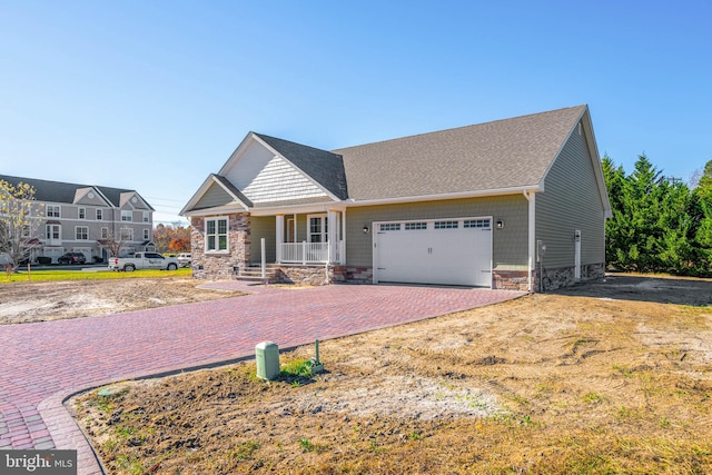 craftsman-style home with a porch and a garage