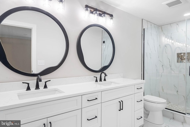 bathroom with a shower with door, vanity, and toilet