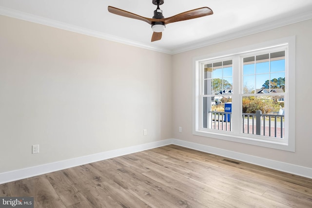 spare room with ceiling fan, light wood-type flooring, and ornamental molding