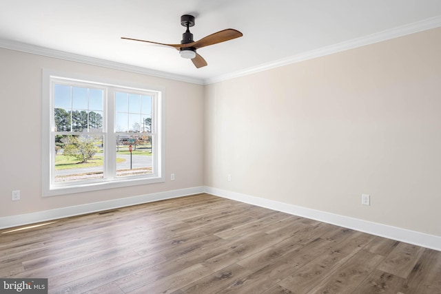 spare room featuring ceiling fan, wood-type flooring, and ornamental molding