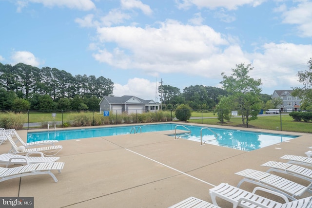 view of swimming pool with a patio