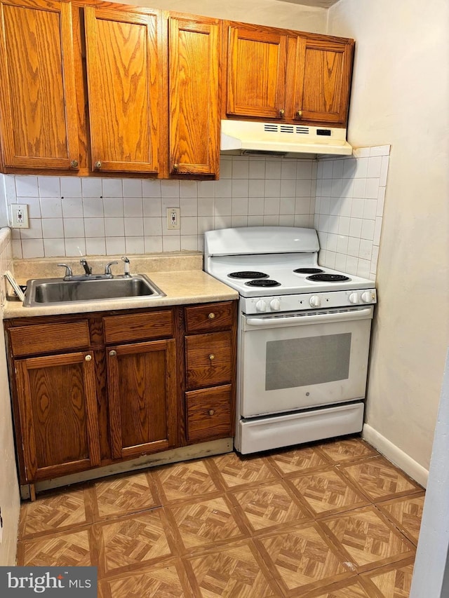 kitchen featuring backsplash, sink, light parquet flooring, and white stove