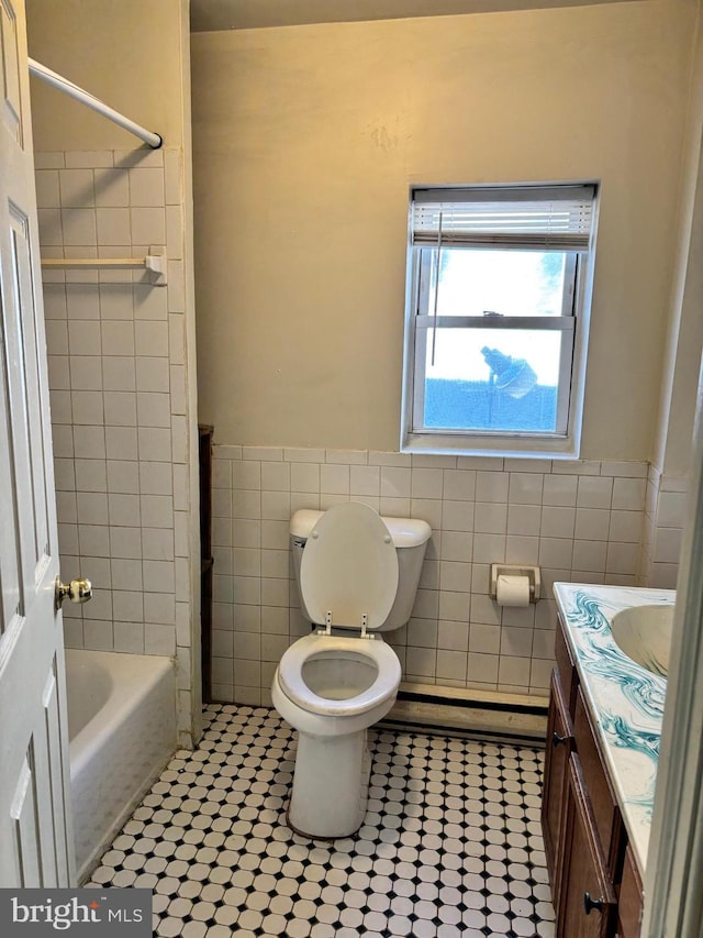 full bathroom with tile patterned floors, tub / shower combination, vanity, tile walls, and toilet