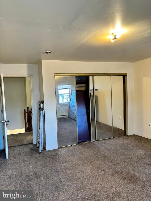 unfurnished bedroom with carpet and a closet