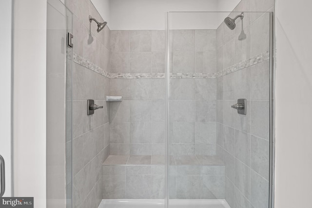 bathroom featuring a shower with shower door