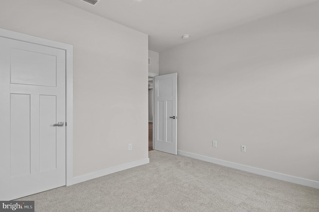 unfurnished bedroom featuring light carpet