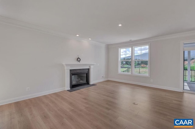 unfurnished living room with ornamental molding, light hardwood / wood-style floors, and plenty of natural light