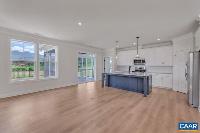 kitchen featuring appliances with stainless steel finishes, hanging light fixtures, crown molding, white cabinets, and light wood-type flooring