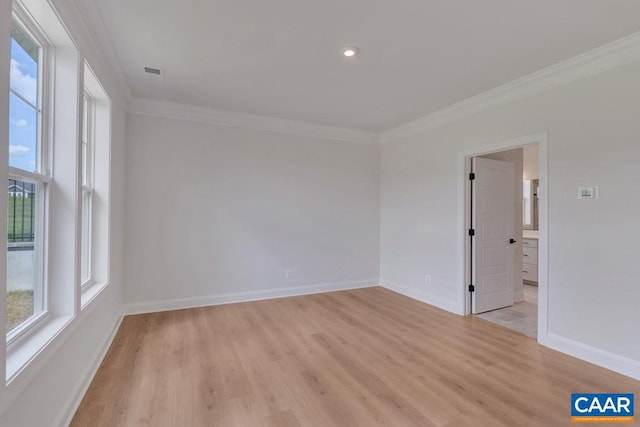 spare room with light hardwood / wood-style flooring and ornamental molding