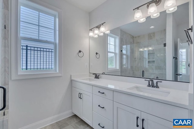 bathroom with walk in shower and vanity