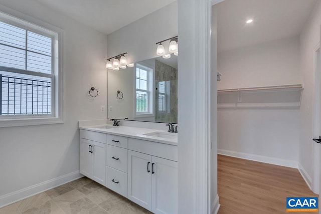 bathroom with hardwood / wood-style floors, an enclosed shower, and vanity