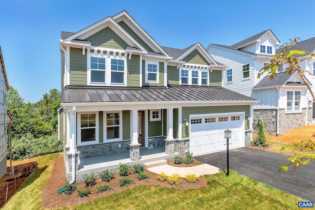 craftsman house with a garage and covered porch