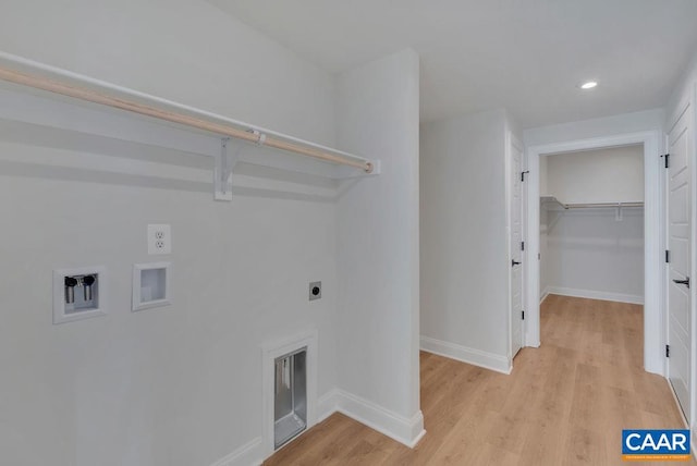 laundry room with light hardwood / wood-style floors, hookup for a washing machine, and electric dryer hookup