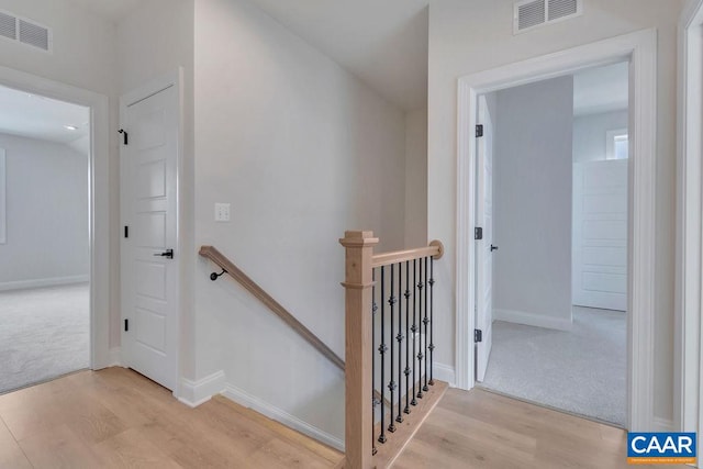 staircase with hardwood / wood-style flooring