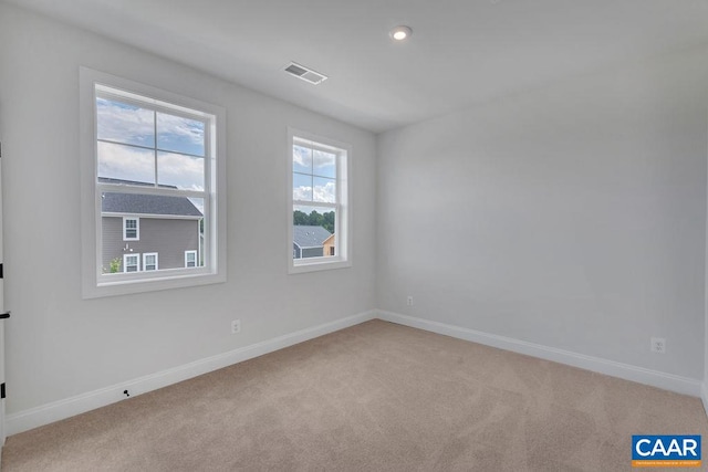 unfurnished room with light carpet