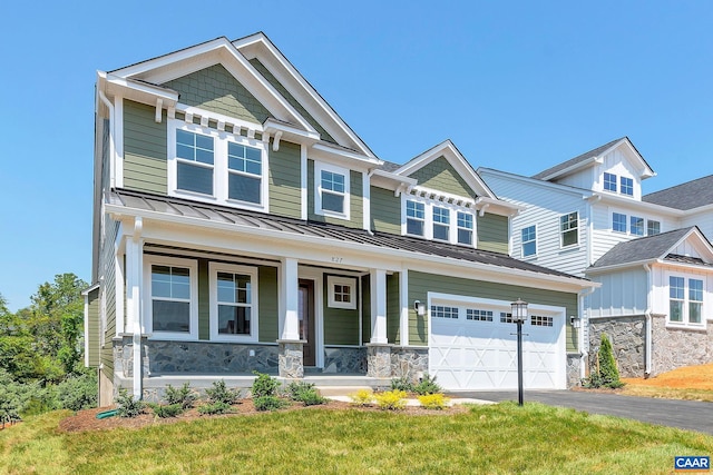 craftsman house with covered porch and a front yard