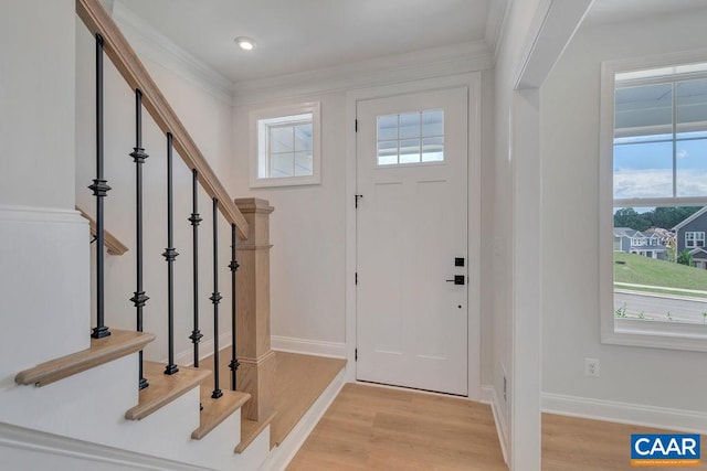 entrance foyer with light wood-type flooring and crown molding