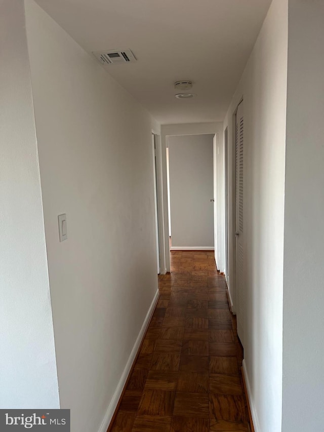 hall with dark parquet flooring