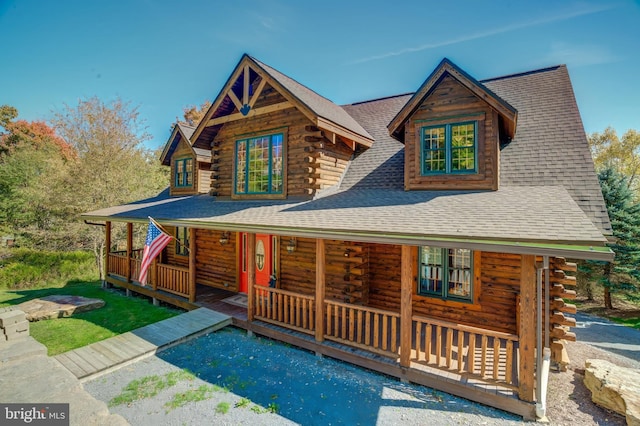 log cabin with a porch