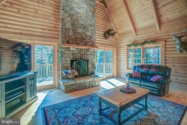 living room featuring a stone fireplace, wood-type flooring, wood ceiling, high vaulted ceiling, and beam ceiling