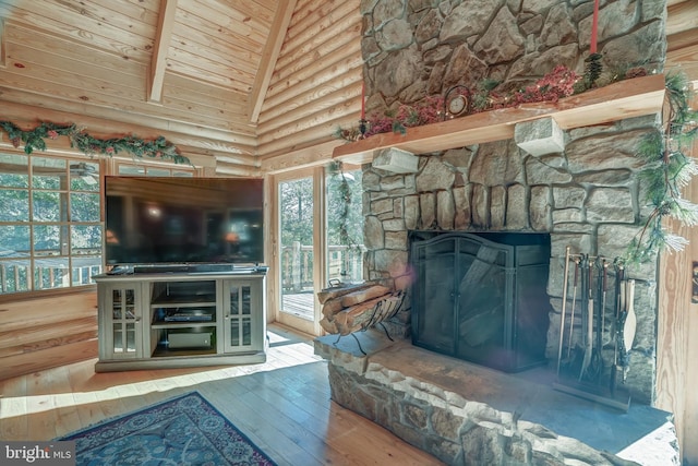 living room featuring wood ceiling, hardwood / wood-style flooring, high vaulted ceiling, beam ceiling, and a fireplace