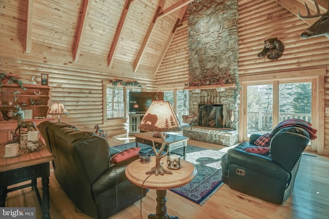 living room featuring a fireplace, hardwood / wood-style flooring, beam ceiling, and high vaulted ceiling