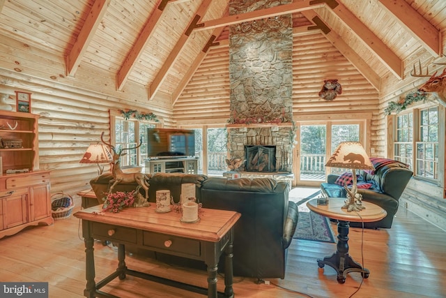 living room with hardwood / wood-style flooring, high vaulted ceiling, beam ceiling, a fireplace, and log walls