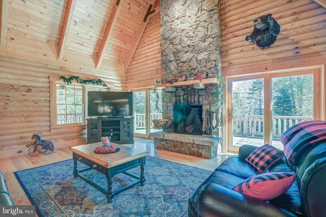 living room with high vaulted ceiling, a fireplace, hardwood / wood-style flooring, and plenty of natural light