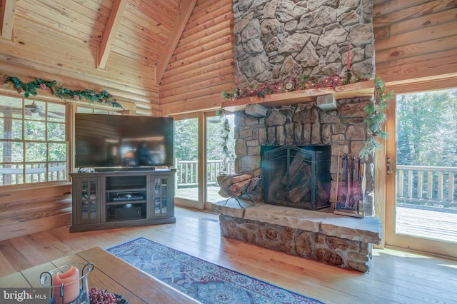 unfurnished living room with hardwood / wood-style floors, a fireplace, plenty of natural light, and high vaulted ceiling