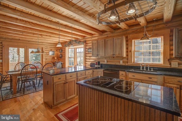 kitchen featuring light hardwood / wood-style floors, a center island, wooden ceiling, pendant lighting, and log walls