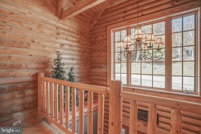 room details featuring beamed ceiling, a chandelier, and log walls