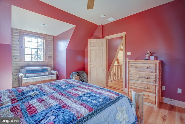 bedroom with wood-type flooring, ceiling fan, and vaulted ceiling