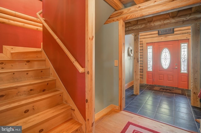 entryway featuring rustic walls and wood-type flooring