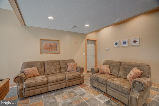 living room featuring a textured ceiling and crown molding