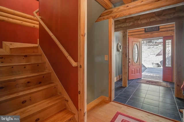 foyer featuring hardwood / wood-style floors and log walls