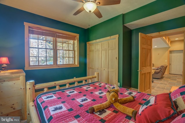 bedroom with ceiling fan and a closet