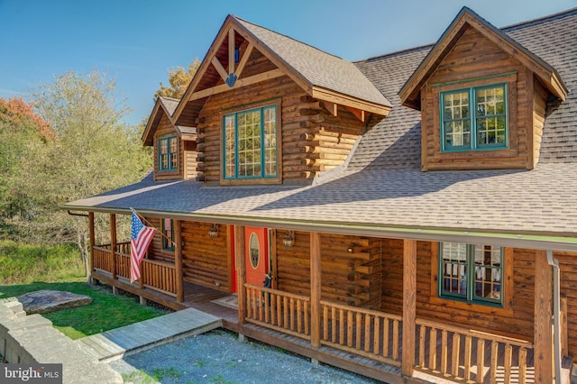 log cabin with covered porch