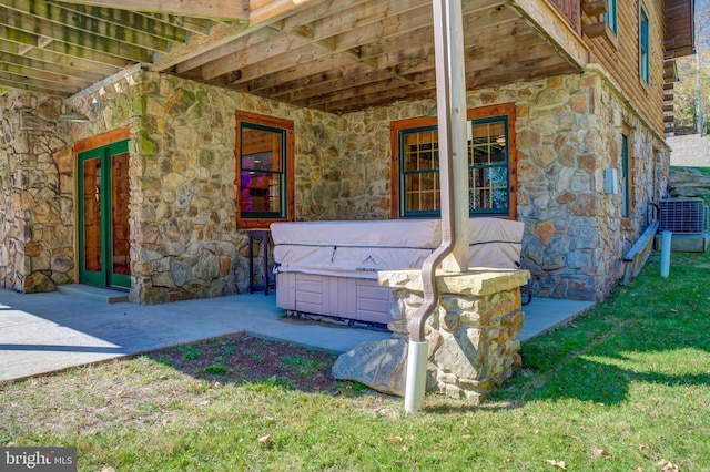 view of patio with central AC and a hot tub