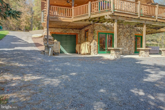 exterior space featuring a balcony, a garage, and a deck