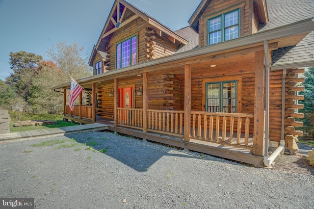 log-style house with a porch