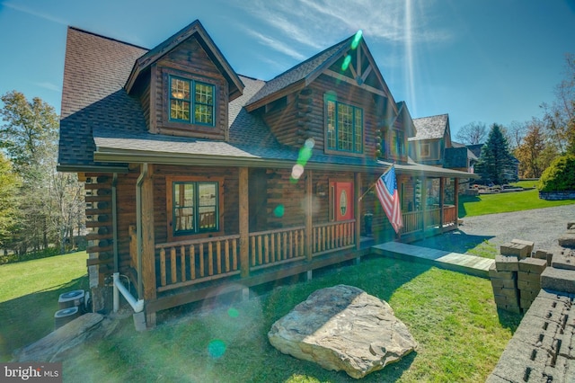 exterior space featuring a porch and a yard