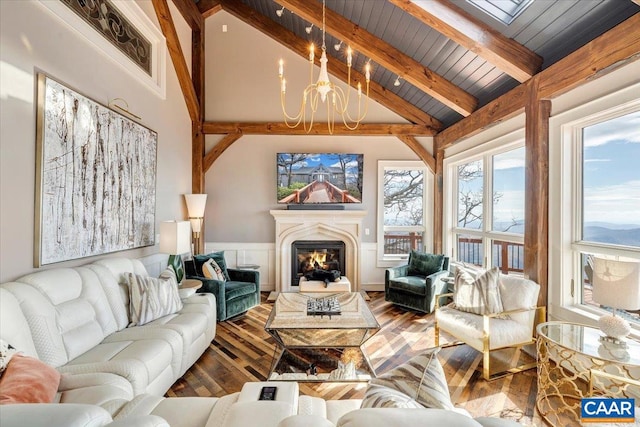 living room with an inviting chandelier, hardwood / wood-style floors, wooden ceiling, high vaulted ceiling, and beamed ceiling