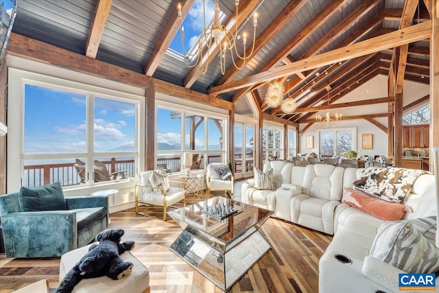 sunroom / solarium featuring wooden ceiling, a water view, an inviting chandelier, and lofted ceiling with skylight