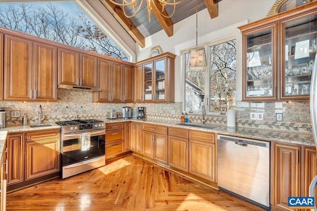 kitchen with backsplash, sink, vaulted ceiling with beams, and stainless steel appliances