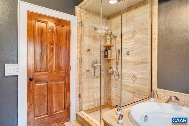 bathroom featuring shower with separate bathtub, sink, and a textured ceiling